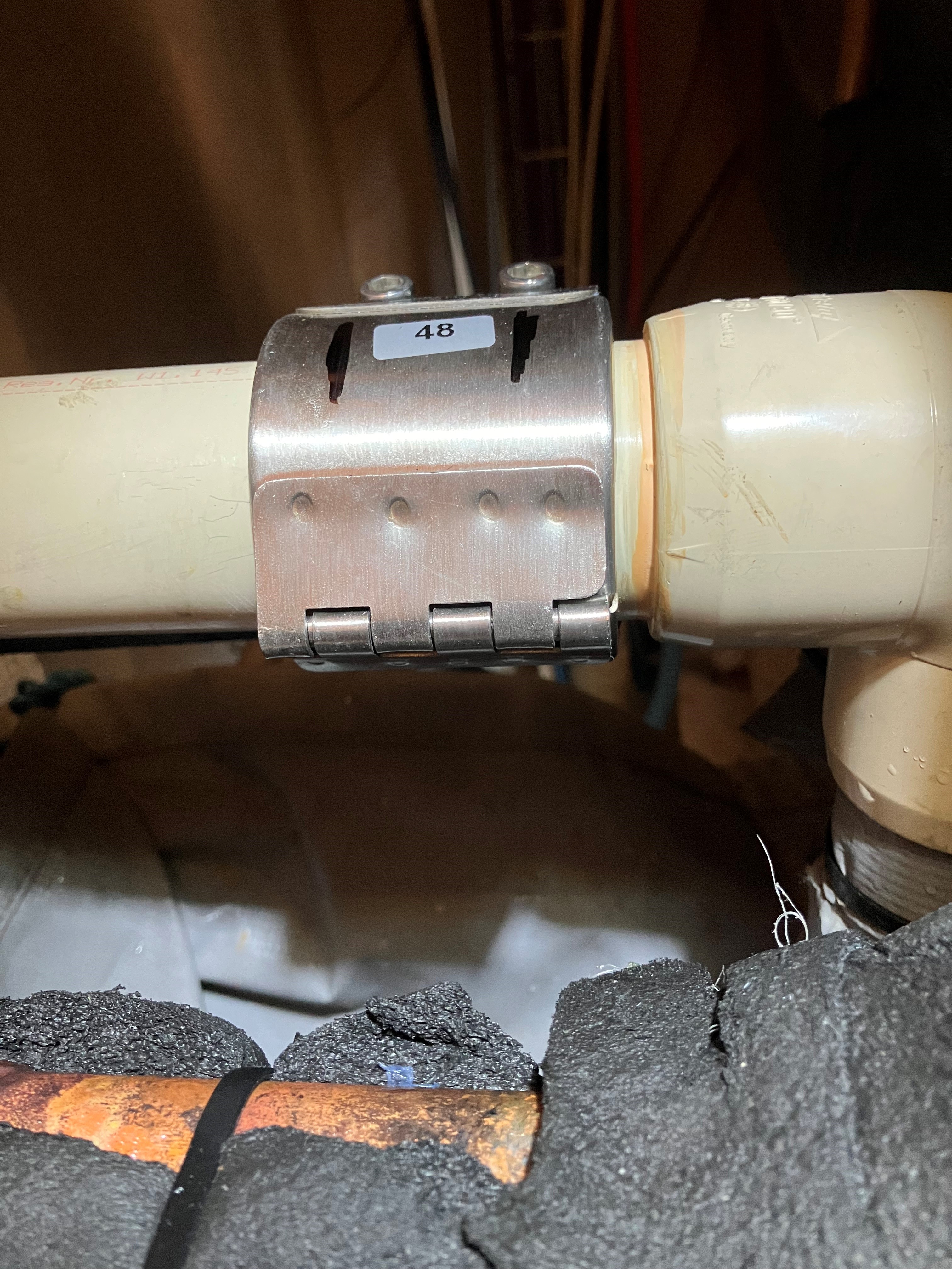 Temporary stainless-steel repair clamp on cracked Friatherm Durapipe