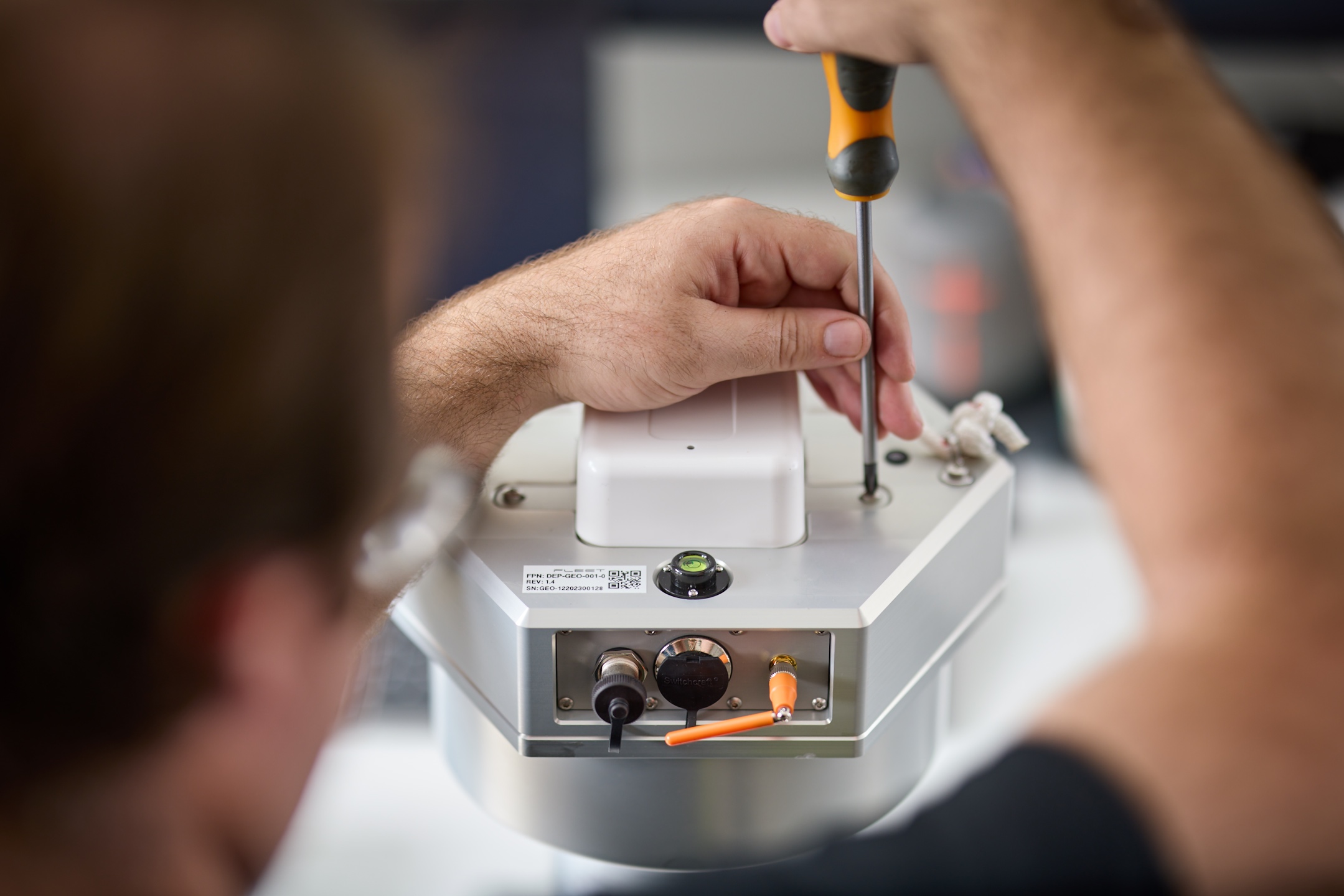A person using a screwdriver on an ExoSphere geode