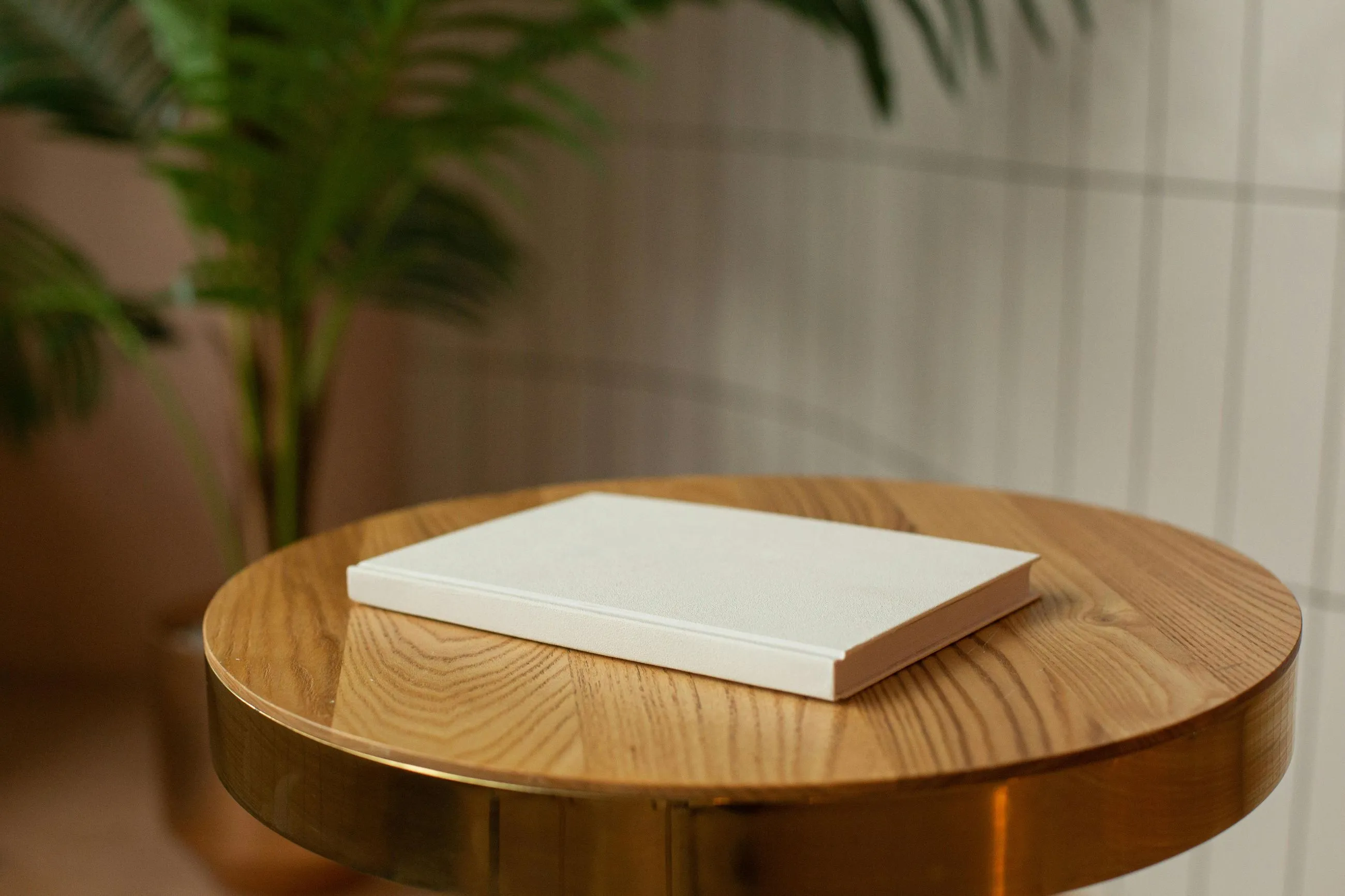 A white book sitting on top of a wooden table.