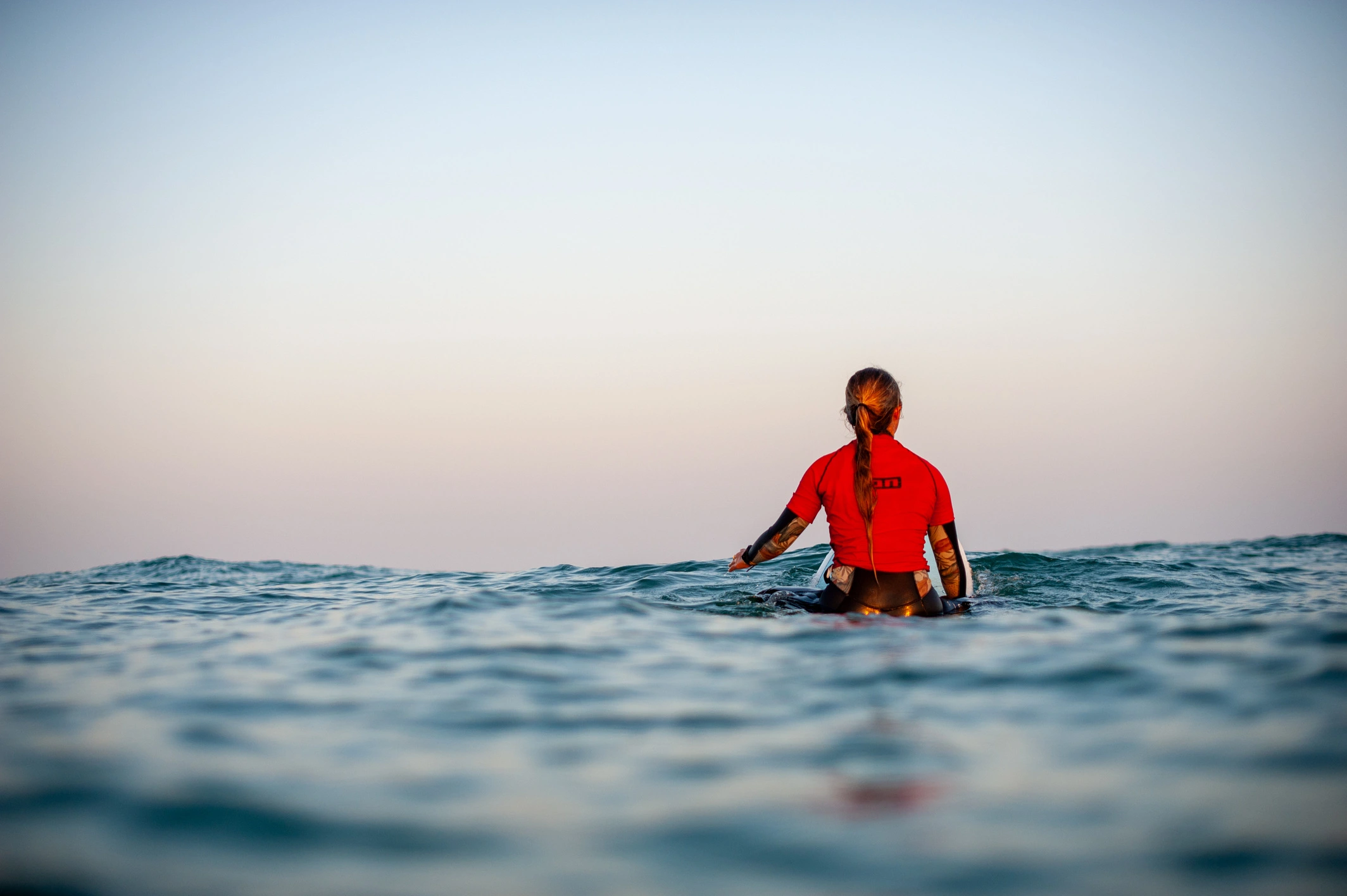 surfeuse regardant le large sur sa planche