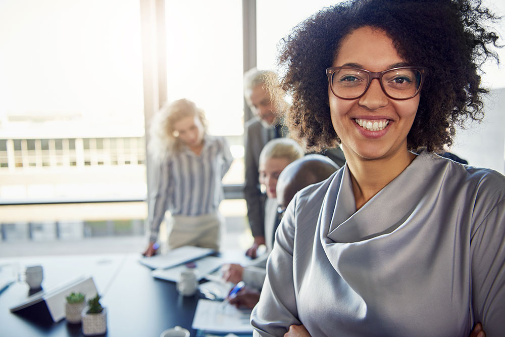 An executive stands in front of her team after combating decision paralysis