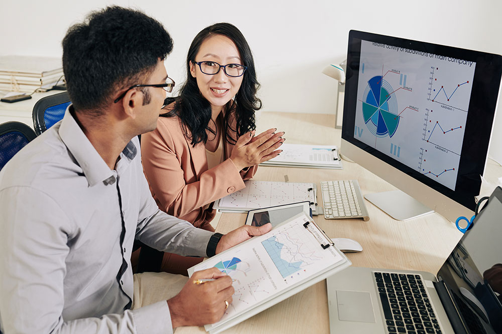 Two executives review employee retention data
