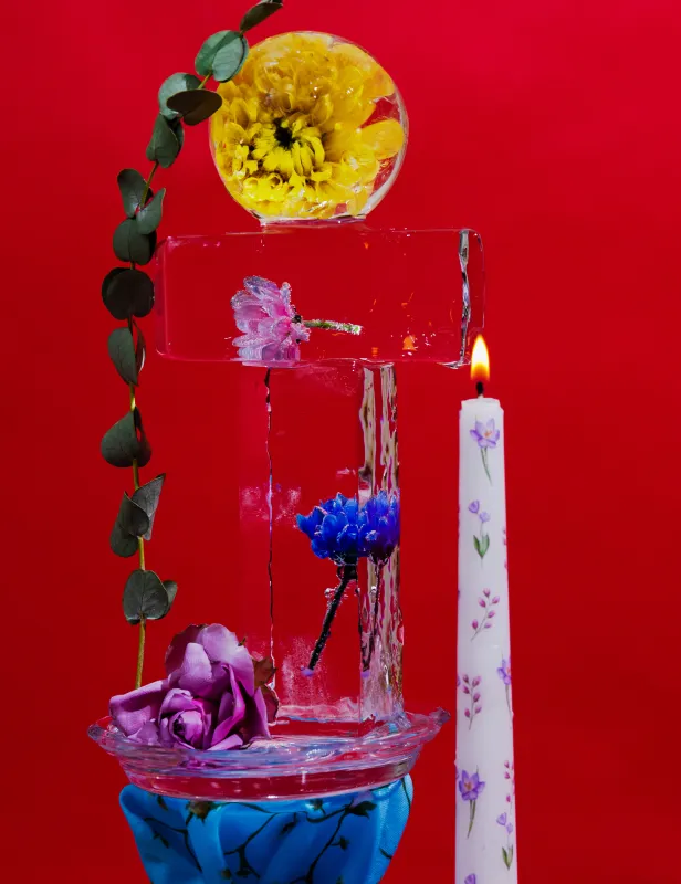 Motorcycle riding on a dirt road winding through a rocky desert canyon landscape.