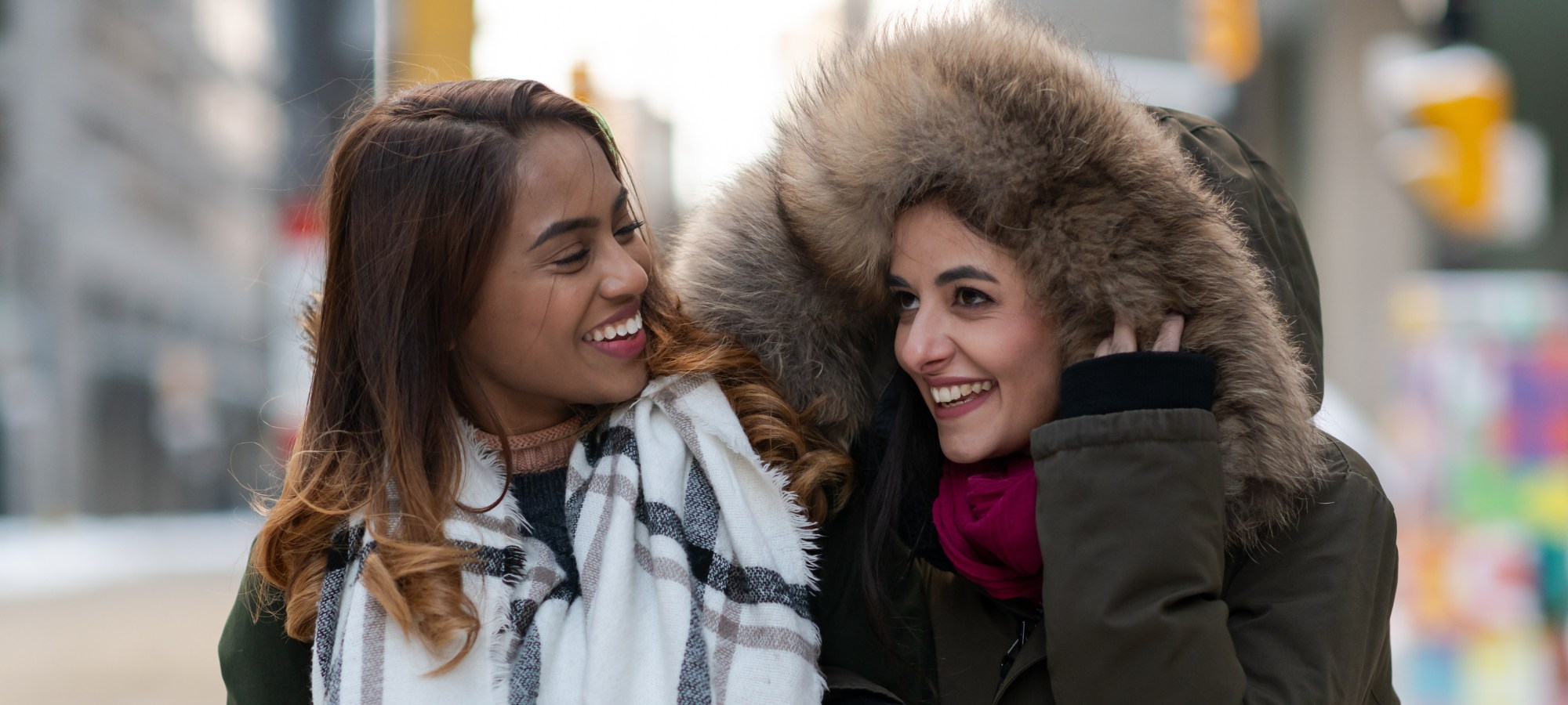 Two female friends smiling.