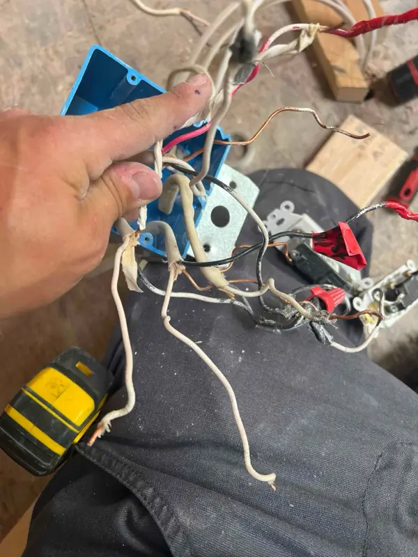 Exposed and improperly connected electrical wiring inside a junction box, highlighting the need for professional electrical repair services in Albuquerque