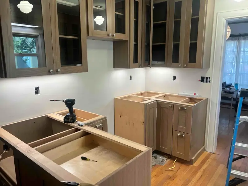 Kitchen remodel in progress with new cabinet installation and electrical and plumbing rough-ins in New Mexico home