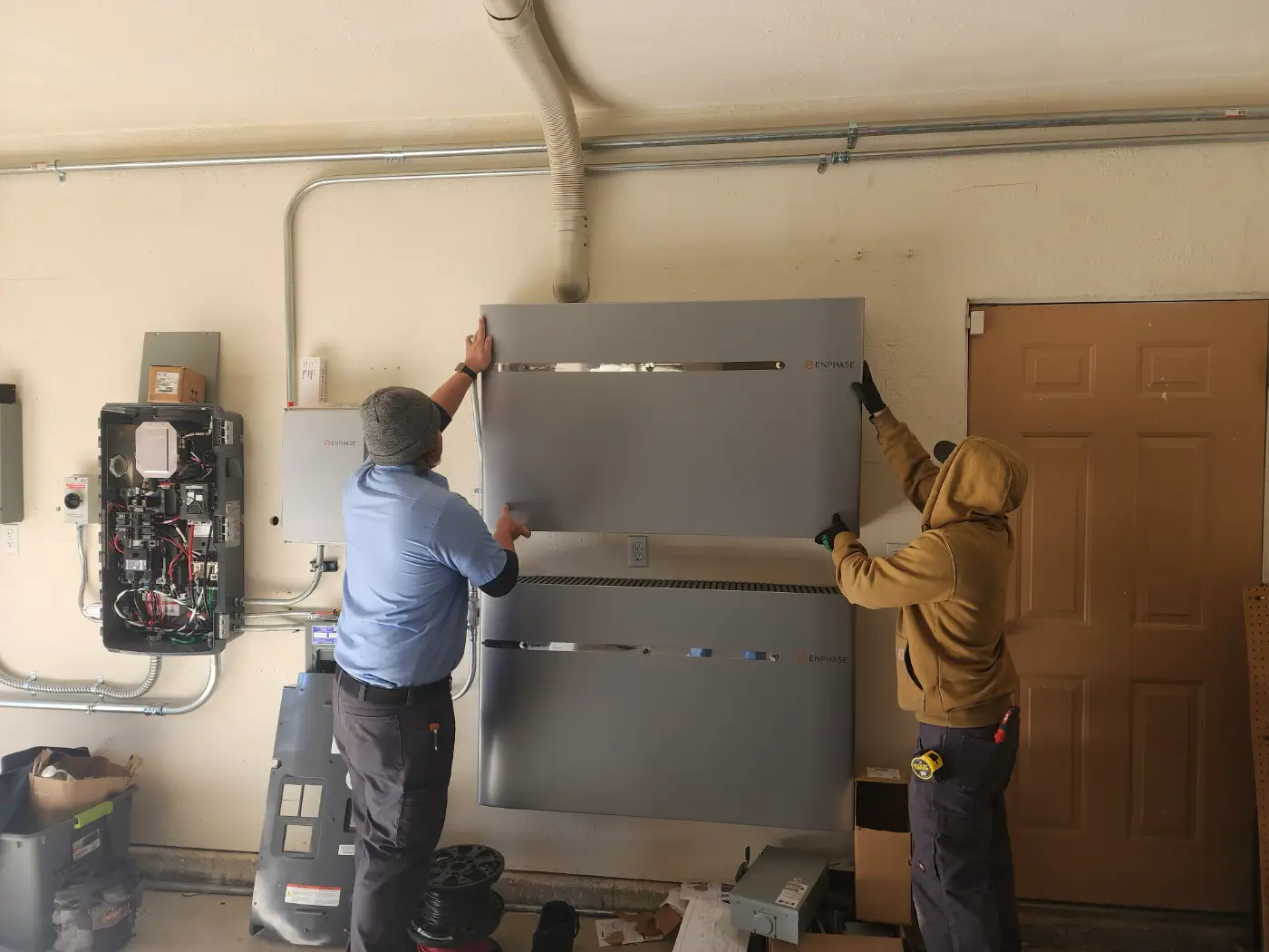 Technicians installing Emphase Solar Battery