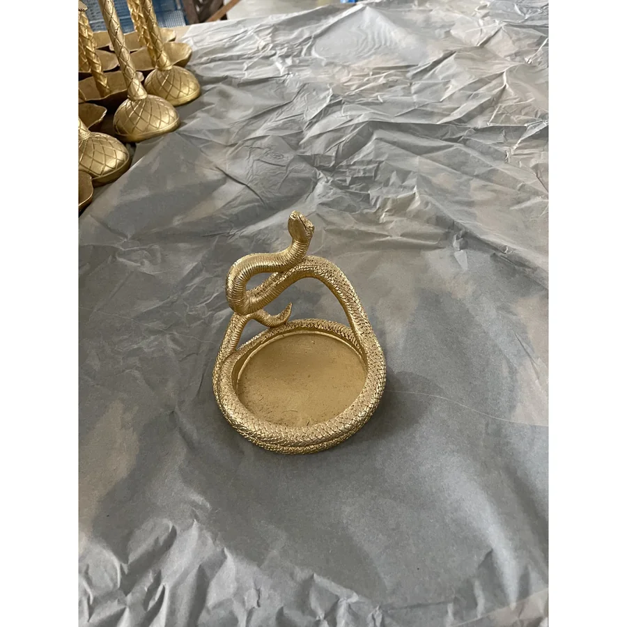 Golden snake-shaped decorative tray.