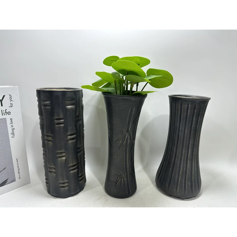 Black ceramic textured vases with plant.