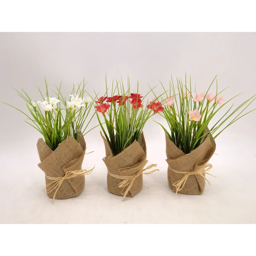 Burlap-wrapped artificial flower pots with blooms.