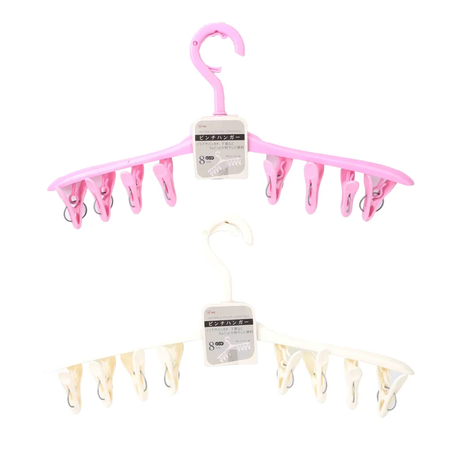 Pink and white multi-clip hangers for drying clothes.