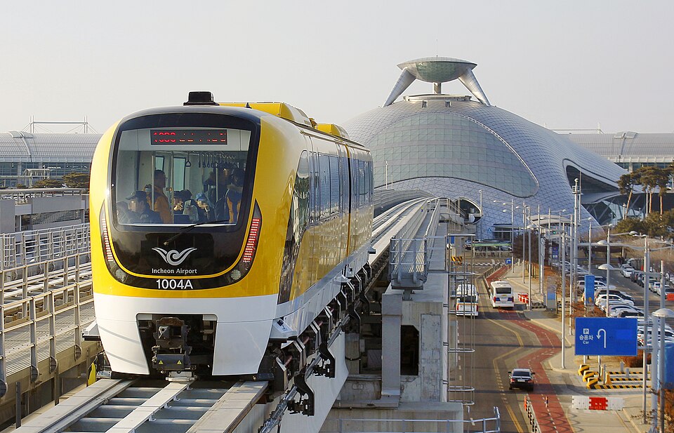 An Incheon Airport maglev train on an elevated track beside the terminal. Image Credit: Minseong Kim