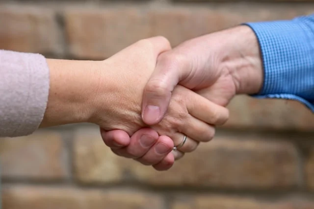 Two people shaking hands.