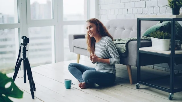 Creator recording a video at home with a camera on a tripod.