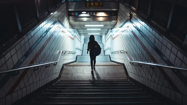 Person on a stairway at a subway entrance. Photo by Sasha Kaunas on Unsplash