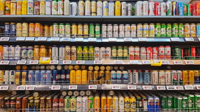 Rows of canned drinks on a convenience-store shelf.