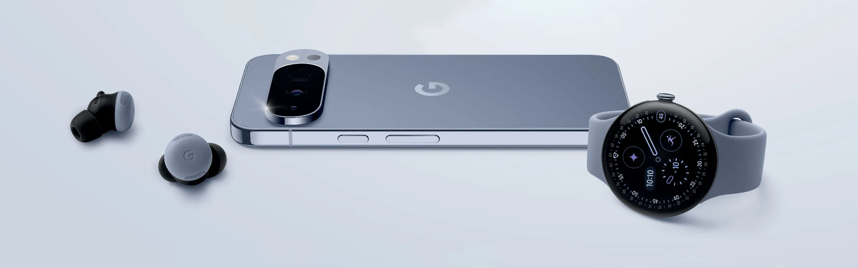 A gray Google Pixel phone, earbuds, and watch are arranged on a light gray surface with the text Google Pixel above them.