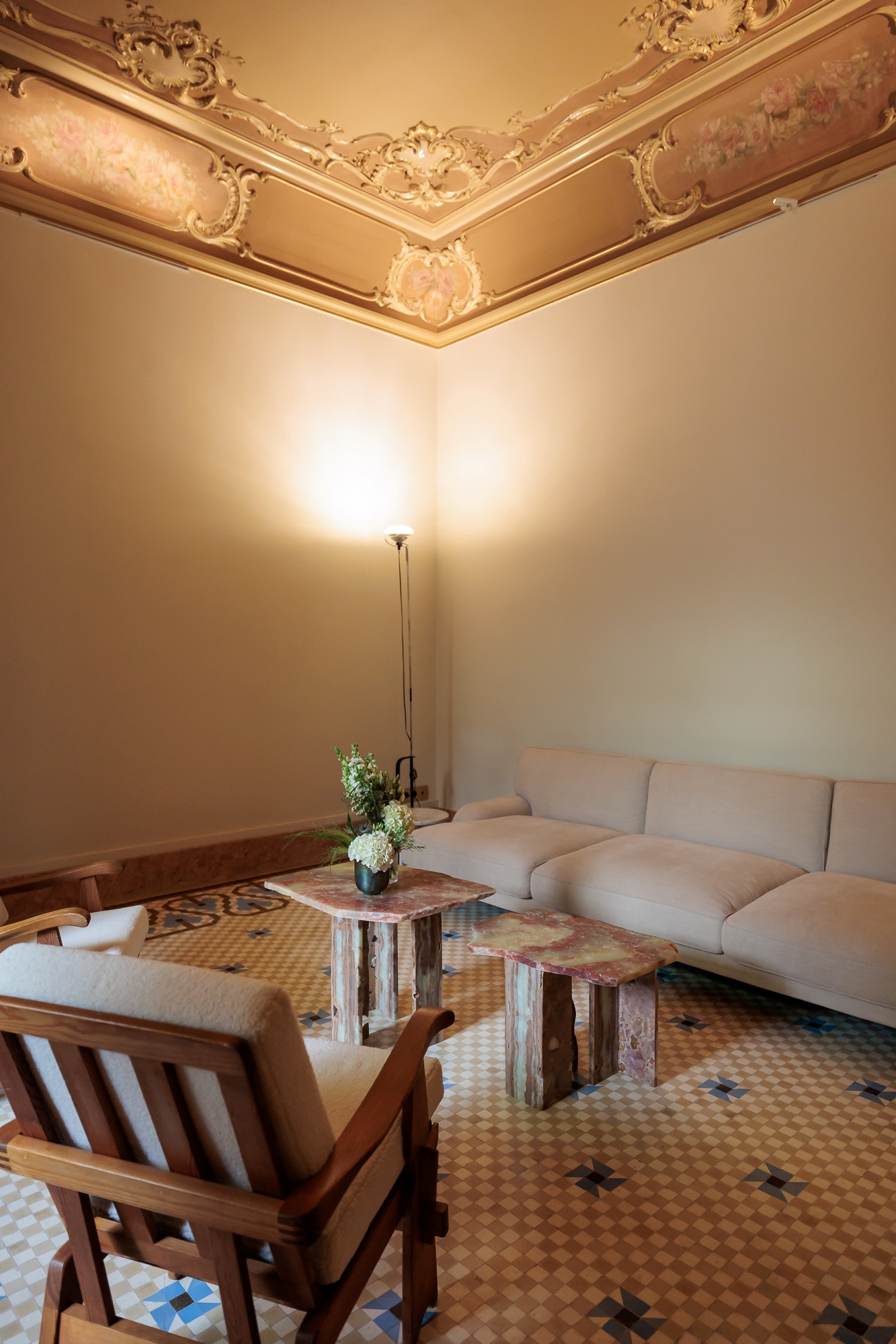 Room with white sofa and gilded coffered ceiling, venue of the Louis Vuitton Cruise 2025 Resee event produced by ESMA Events in Barcelona