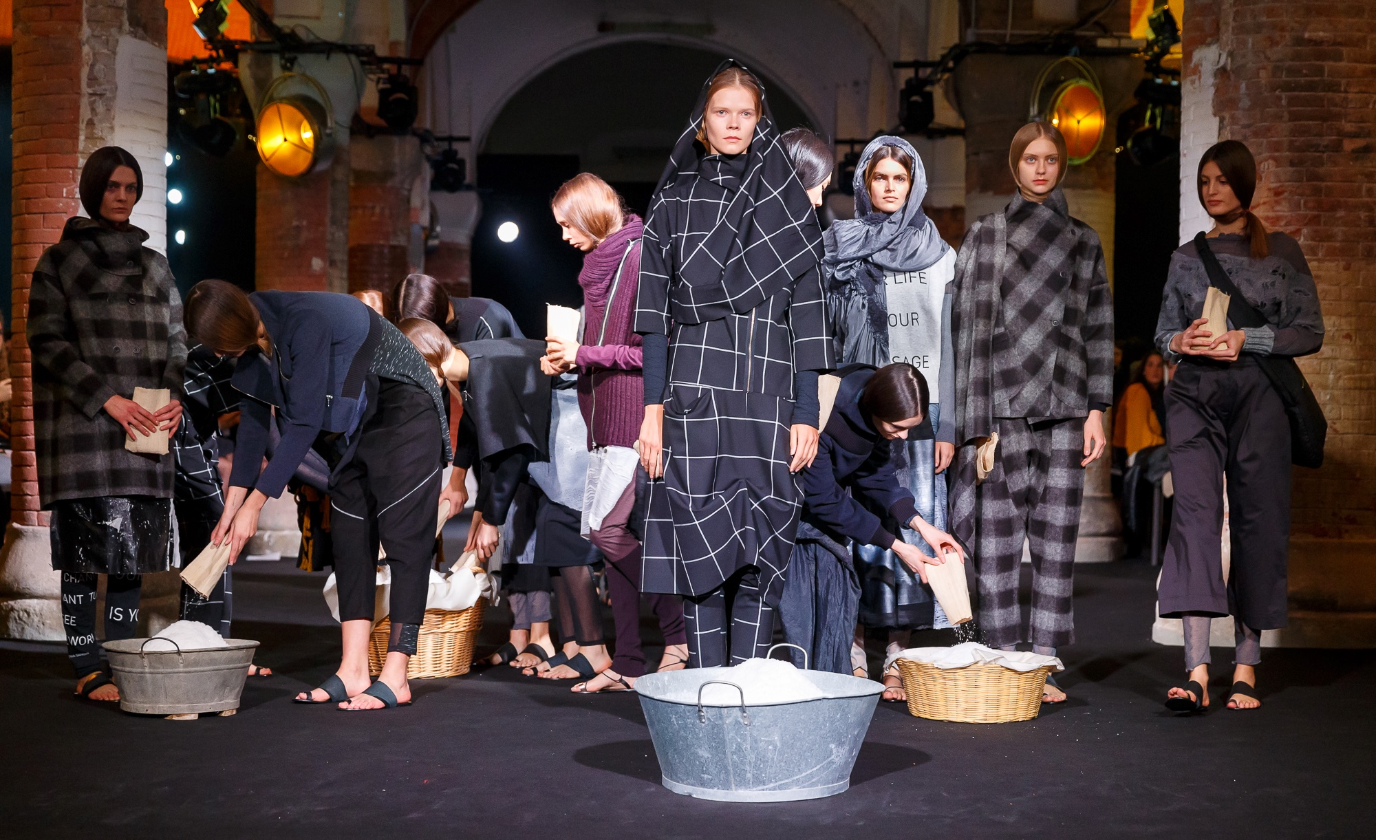 Modelos con prendas de cuadros en un escenario con barreños y cestos de lavandería, 080 Barcelona Fashion FW 2018-2019 producida por ESMA Events