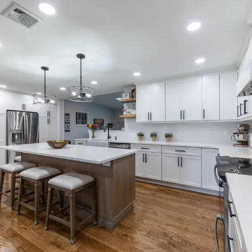 Beautiful White Modern Kitchen With White Marble Counter tops and a beautiful Island
