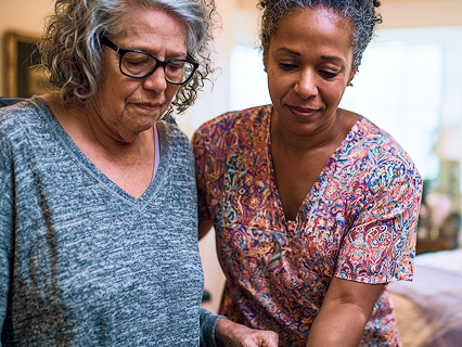In-home caregiver assisting elderly patient