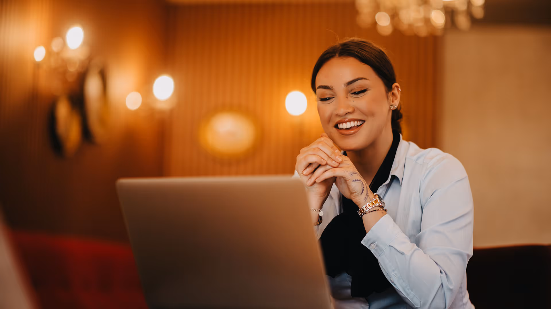 Young small business owner looks at laptop