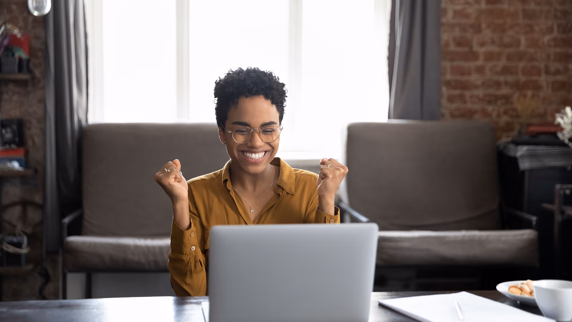 Women looks at paycheck on laptop