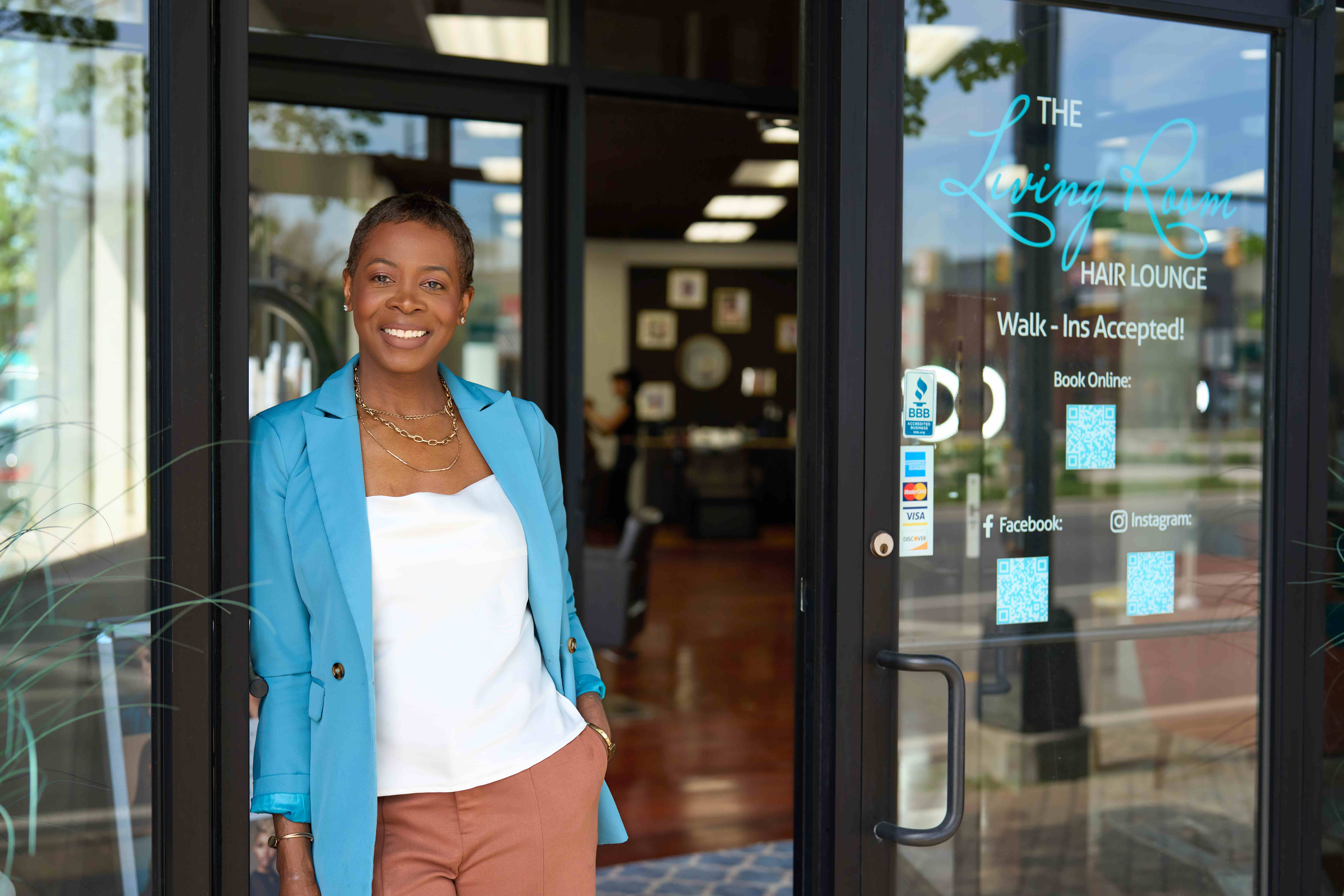 Small business owner opens hair salon and takes care of customers, knowing payroll is cared for by SurePayroll. 
