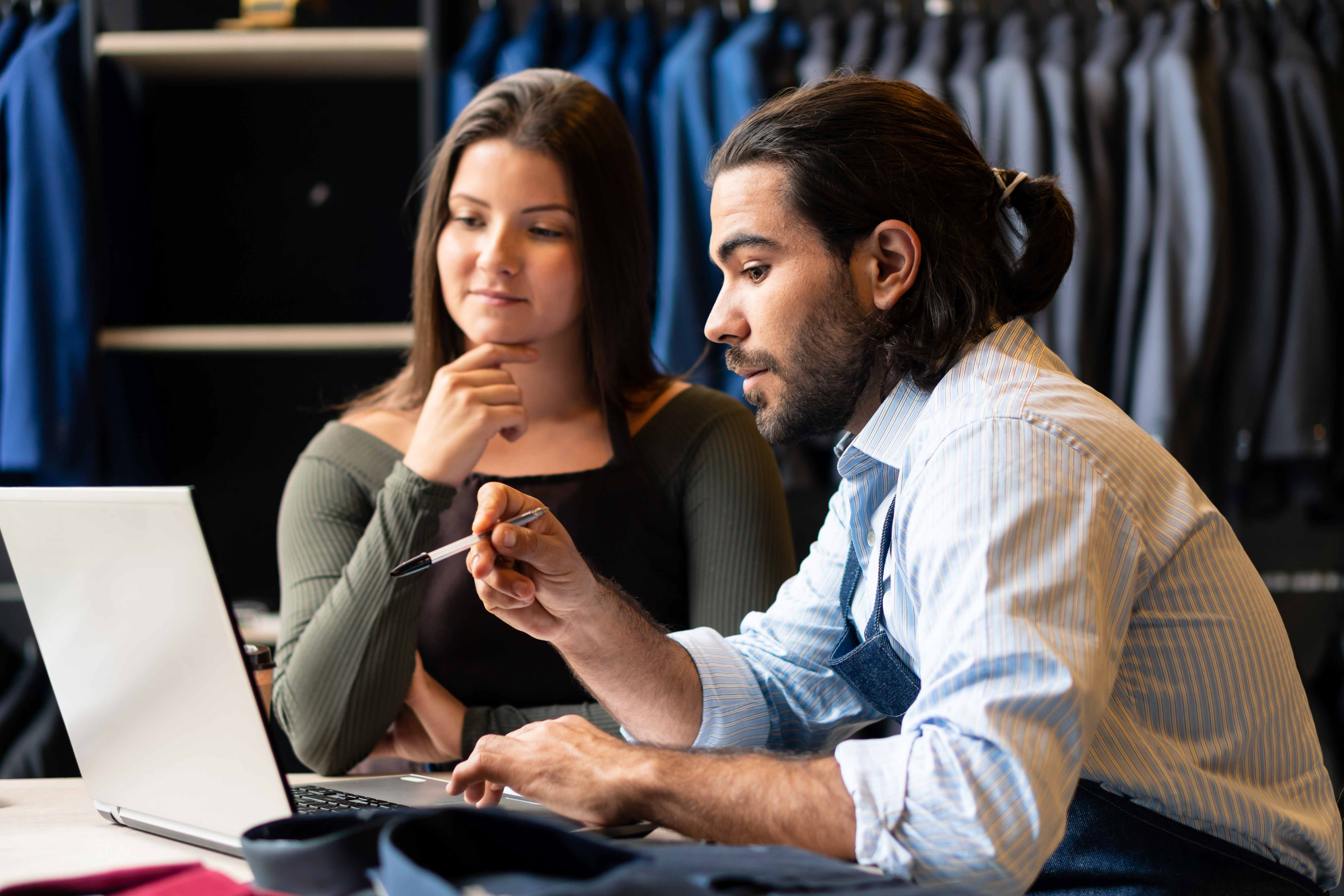 Small business employees review 401(k) plan option available from their employer. 
