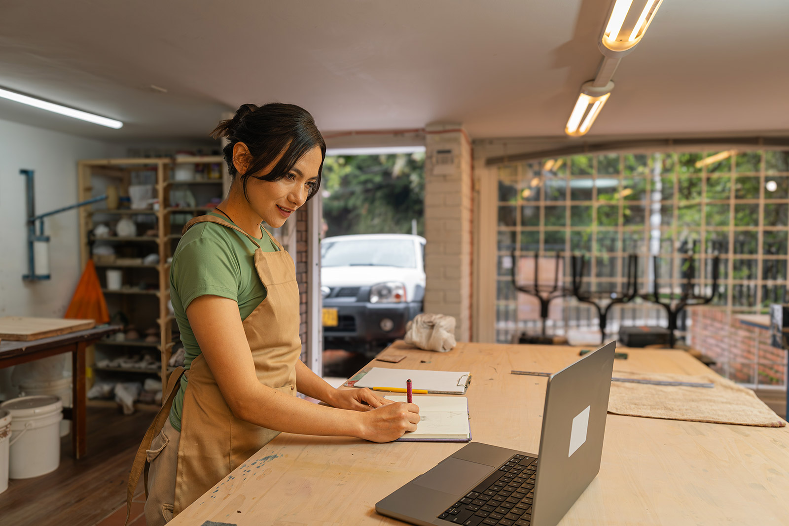 Small business owner in her shop considering retirement plans for her employees