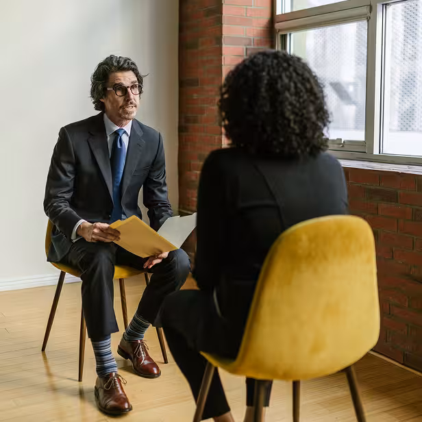 The owner of a small recruiting company screens a candidate for a client.