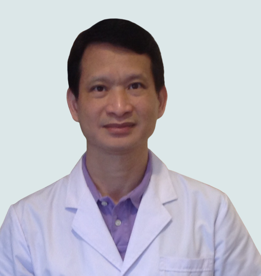 Portrait of a man wearing a white lab coat over a purple collared shirt against a plain light background. Acupuncturist in Richmond BC working at Remedy