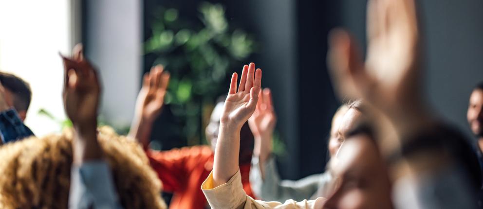 People raising their hands.