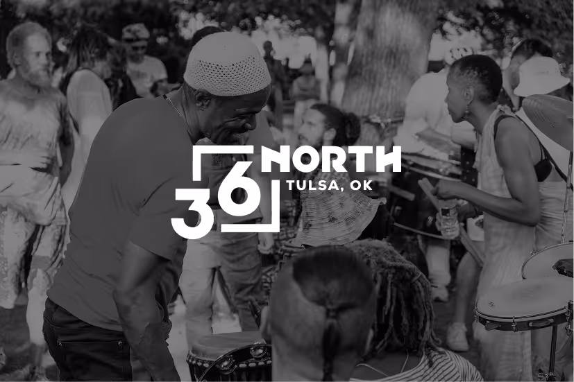 People playing drums and gathering outdoors at a lively community event in Tulsa, Oklahoma.