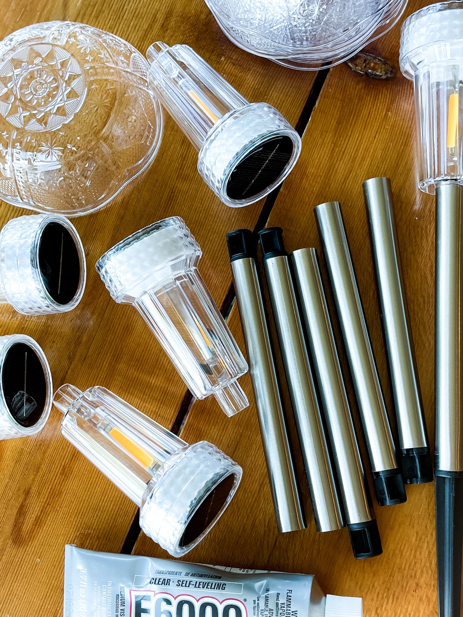 on a table: solar lights, e6000, and plastic bowls 