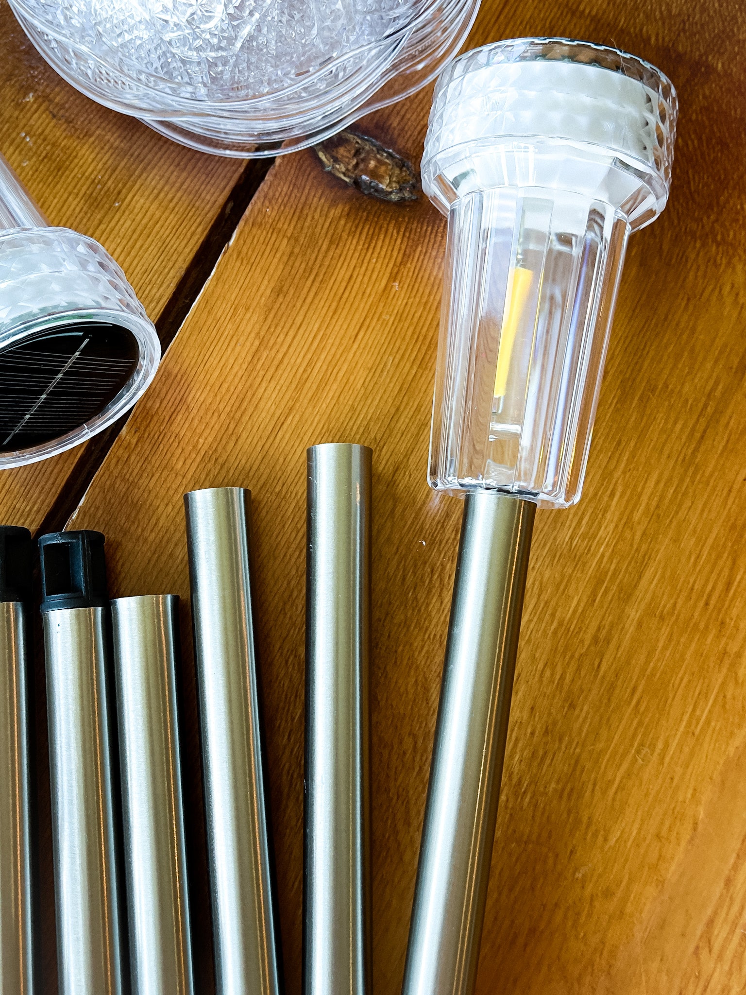 on a table: solar lights, e6000, and plastic bowls 