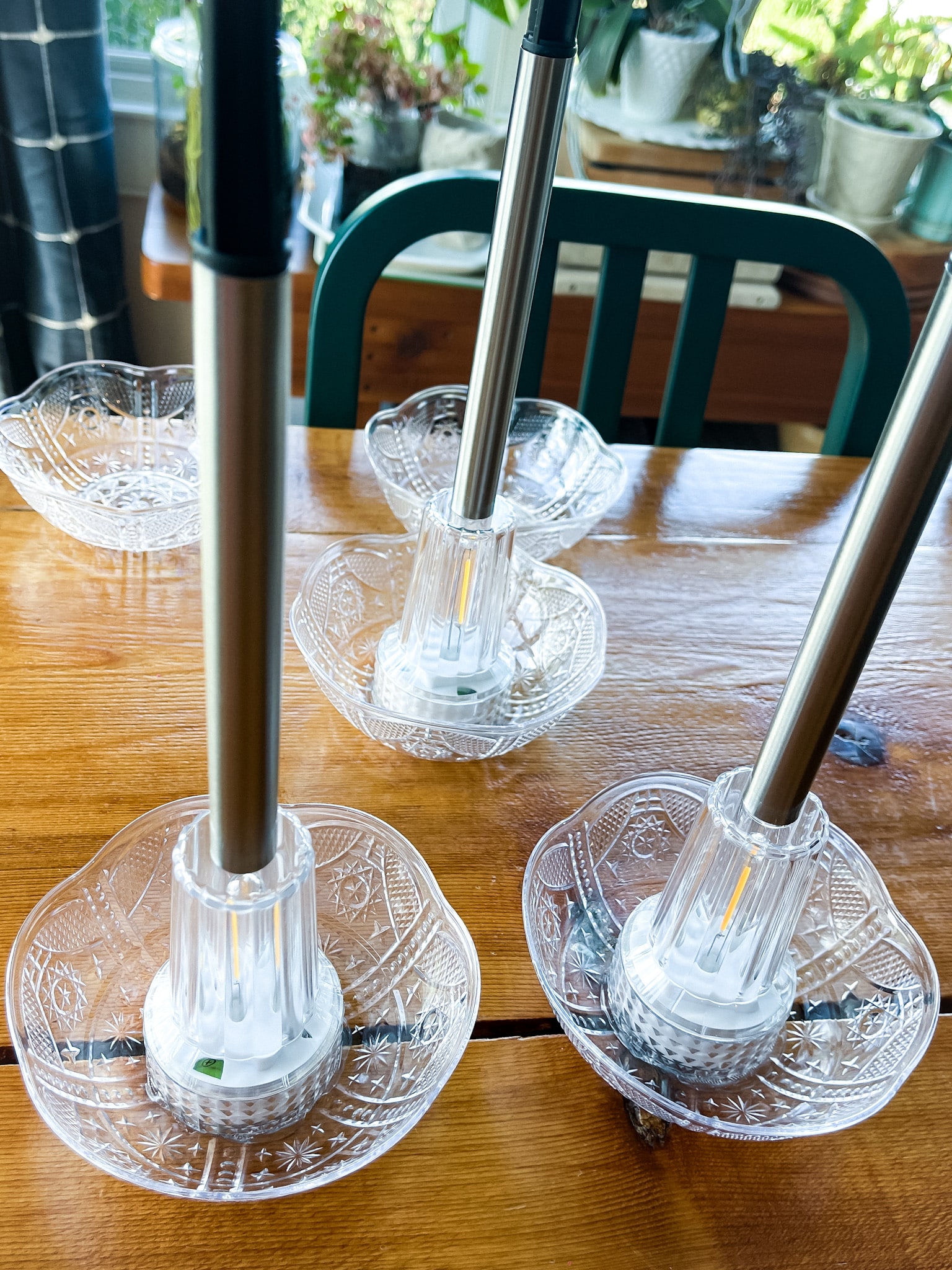 Upgraded solar lights on a table with plastic bowls added to the top