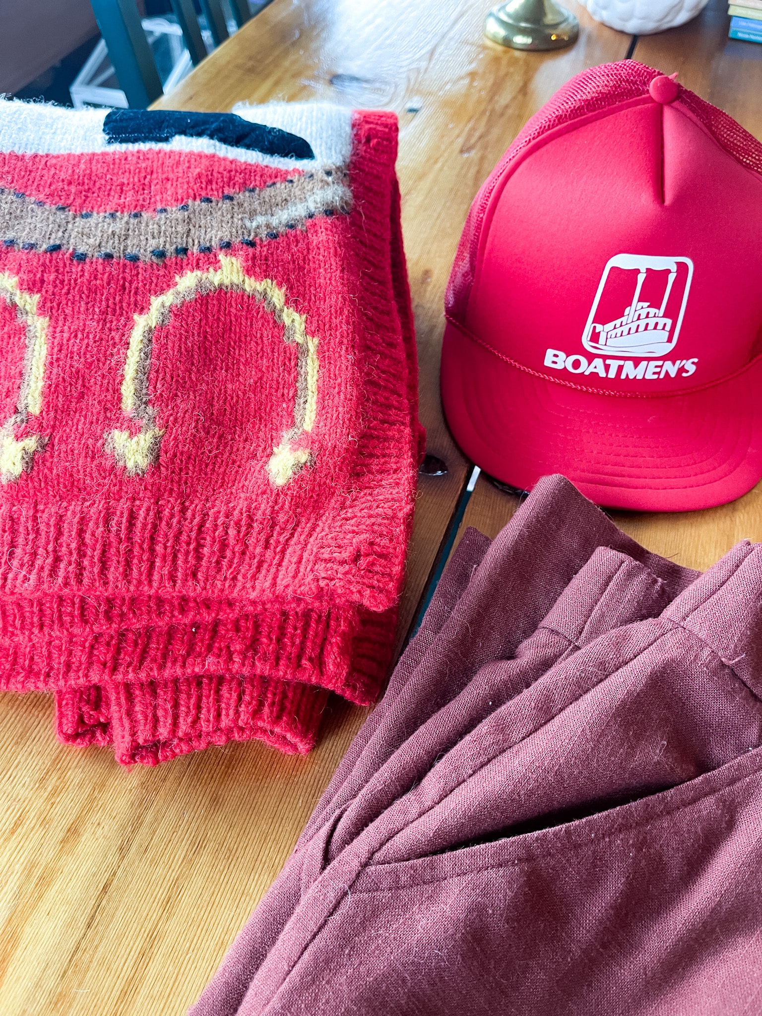 vintage equestrian themed sweater, vintage boatmen's bank hat, russet colored linen pants
