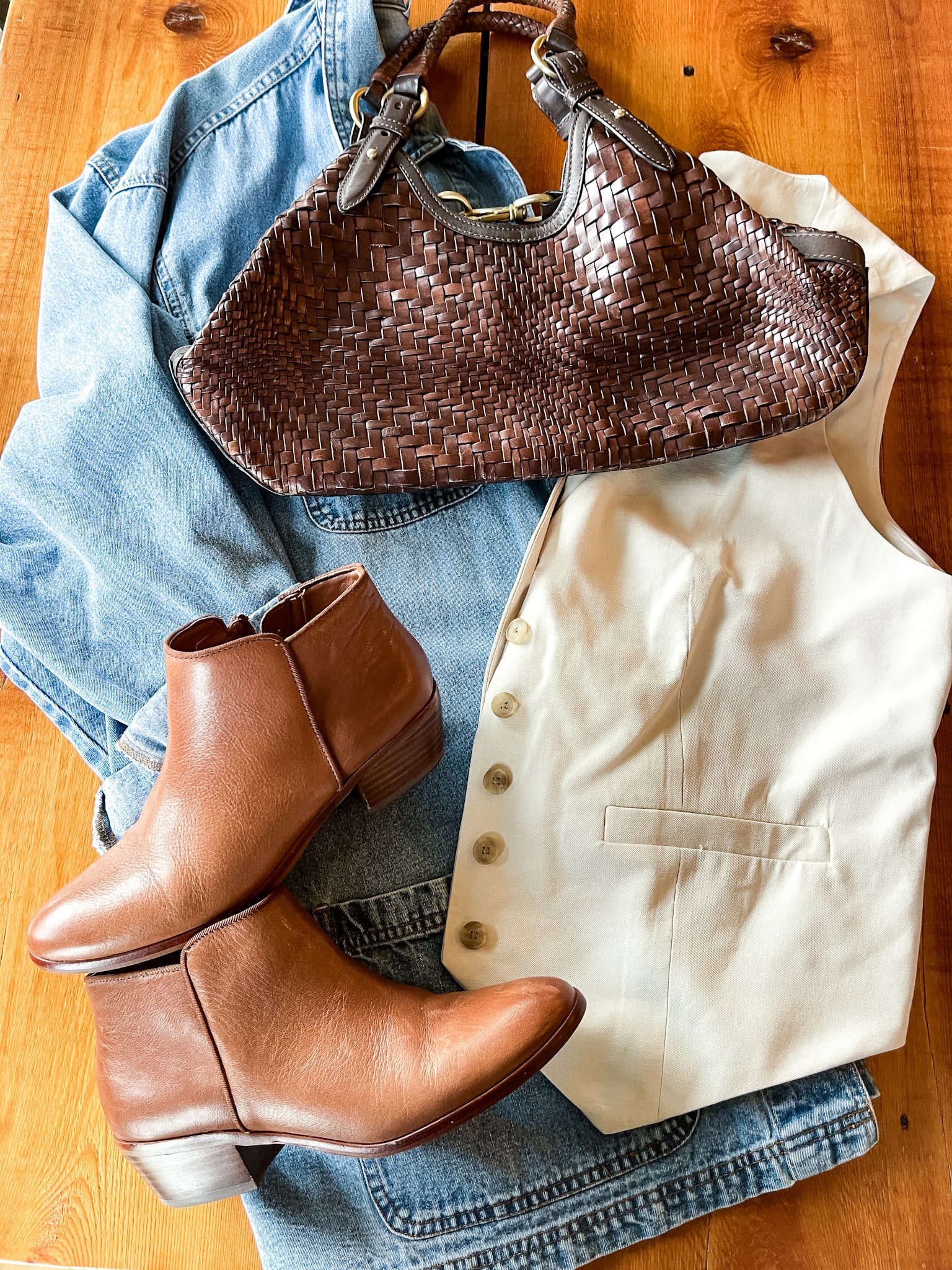 denim barn coat/shacket, brown leather basket weave purse, tan vest, brown leather booties