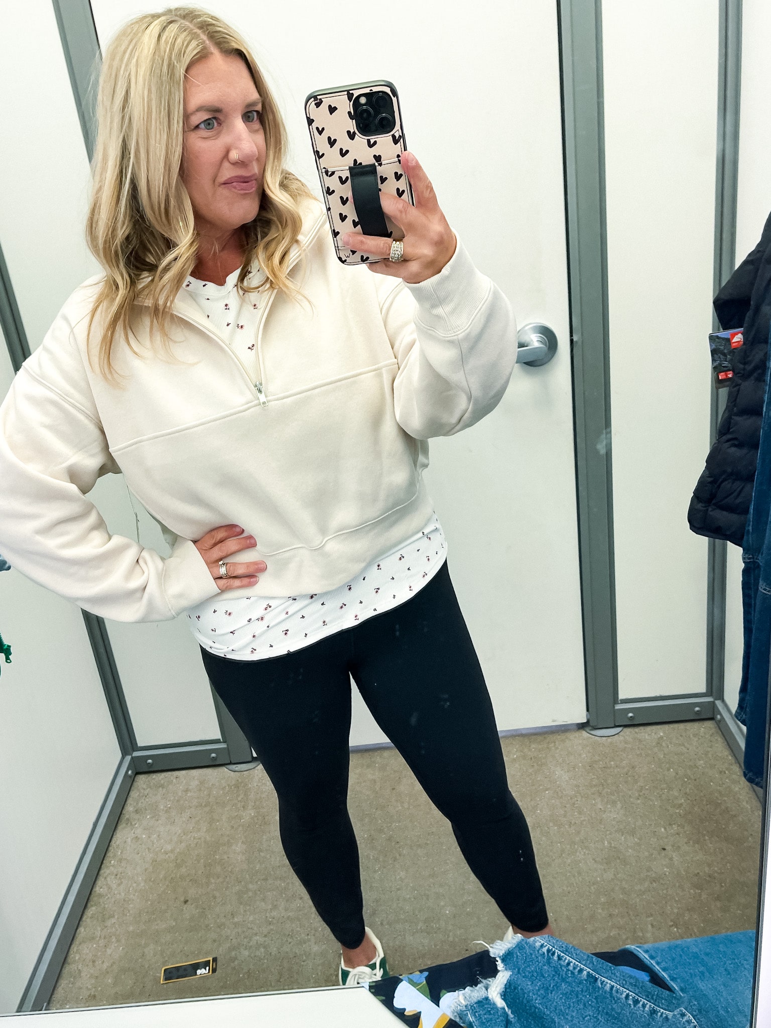 midsize woman trying on clothes at walmart - cream cropped quarter zip and leggings