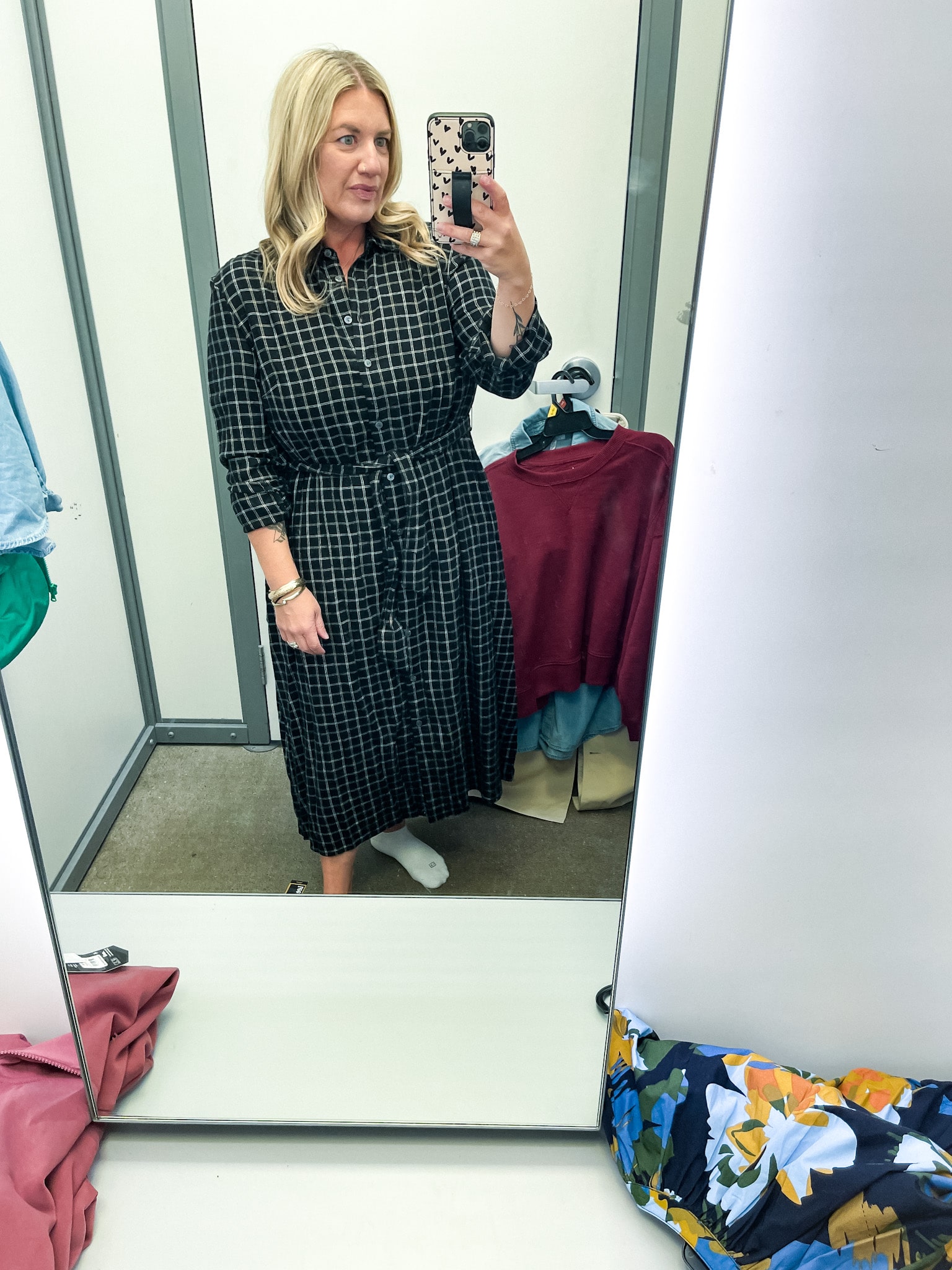 midsize woman trying on clothes at walmart - plaid flannel shirt dress