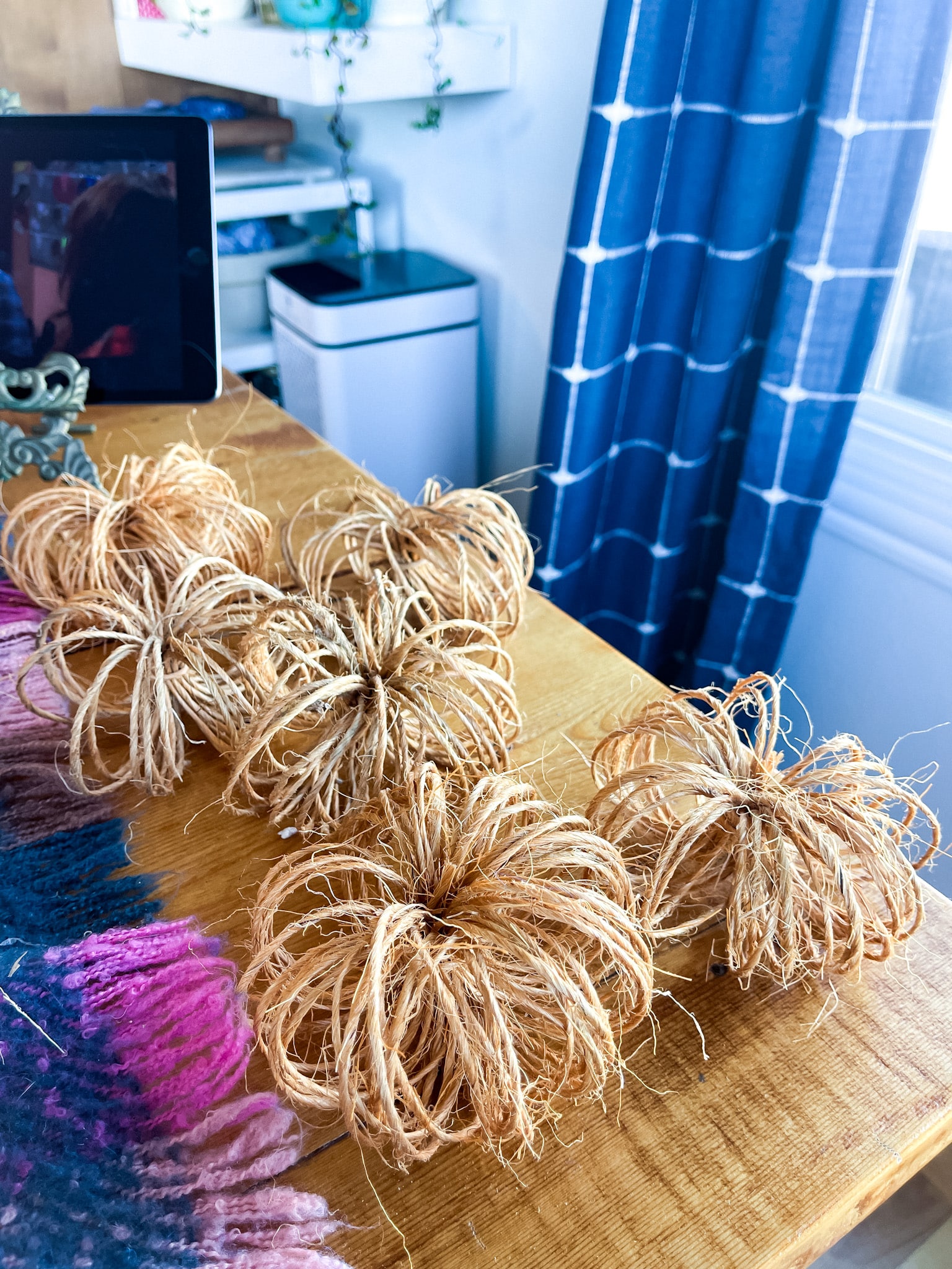 grouping of twine pumpkins on a table