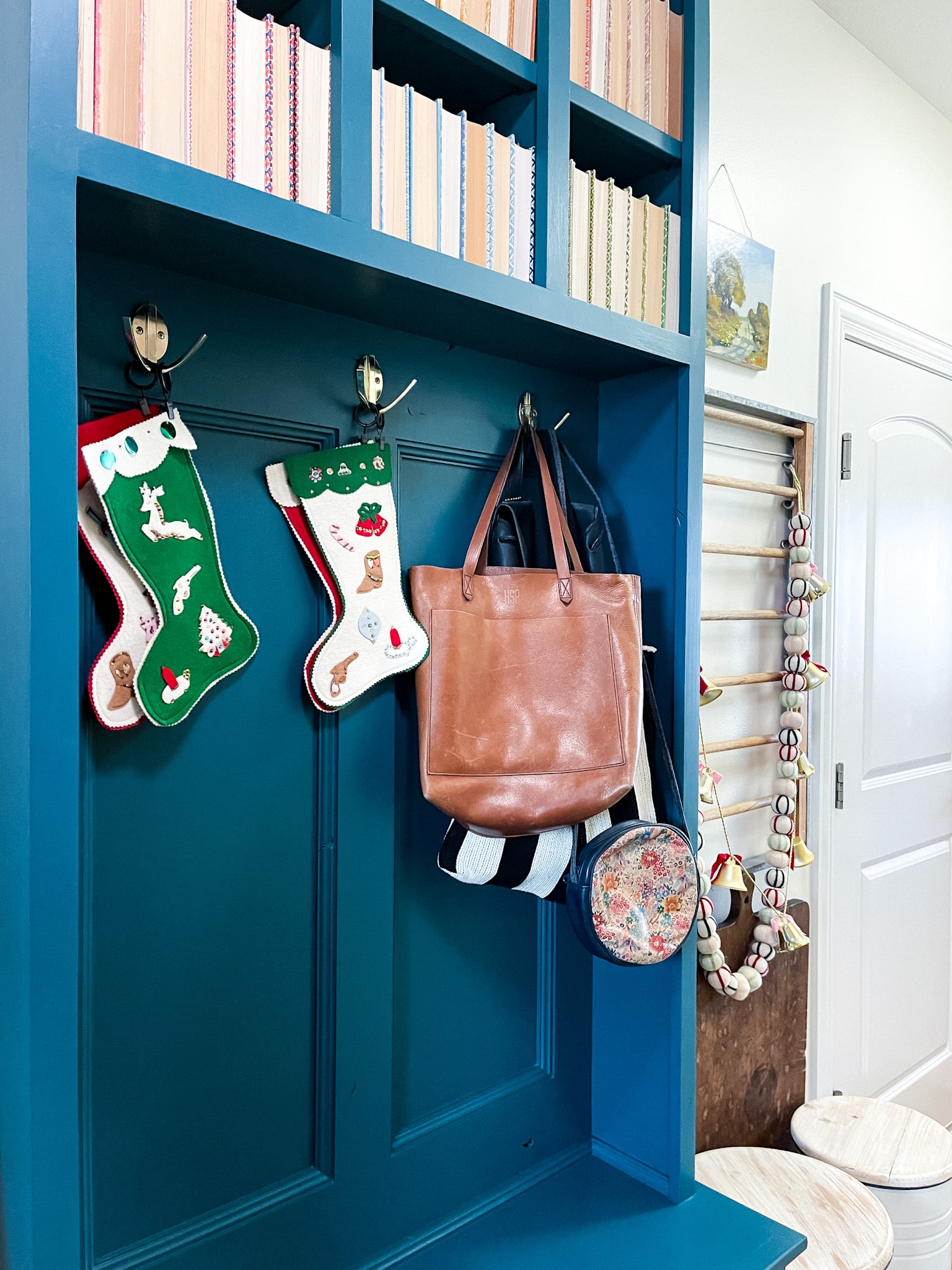 Laundry room with blue shelves decorated with books and vintage Christmas decorations