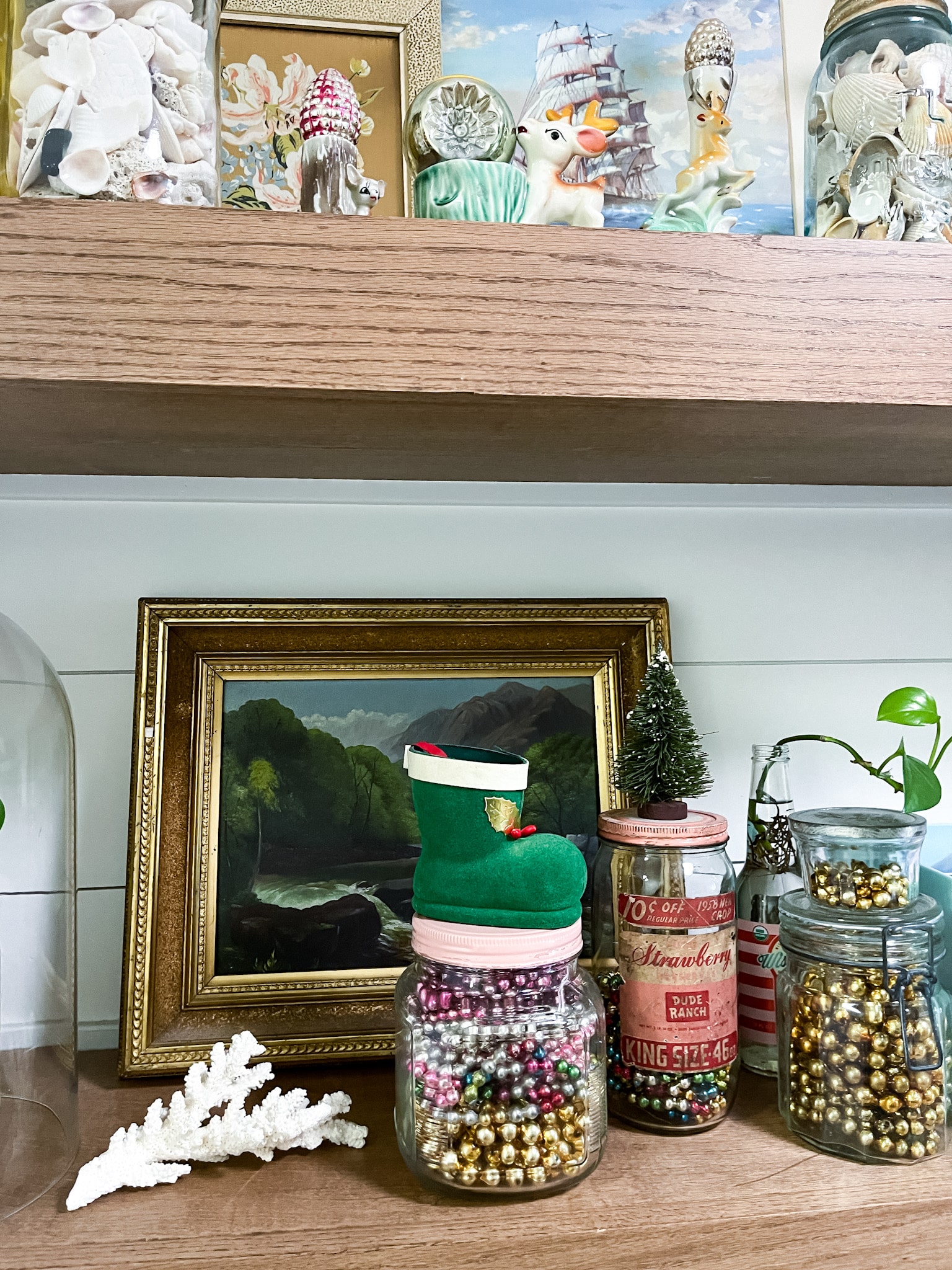 Floating shelves decorated with vintage decor in yellow and pink. Vintage mercury glass garlands styled on the shelves in jars.