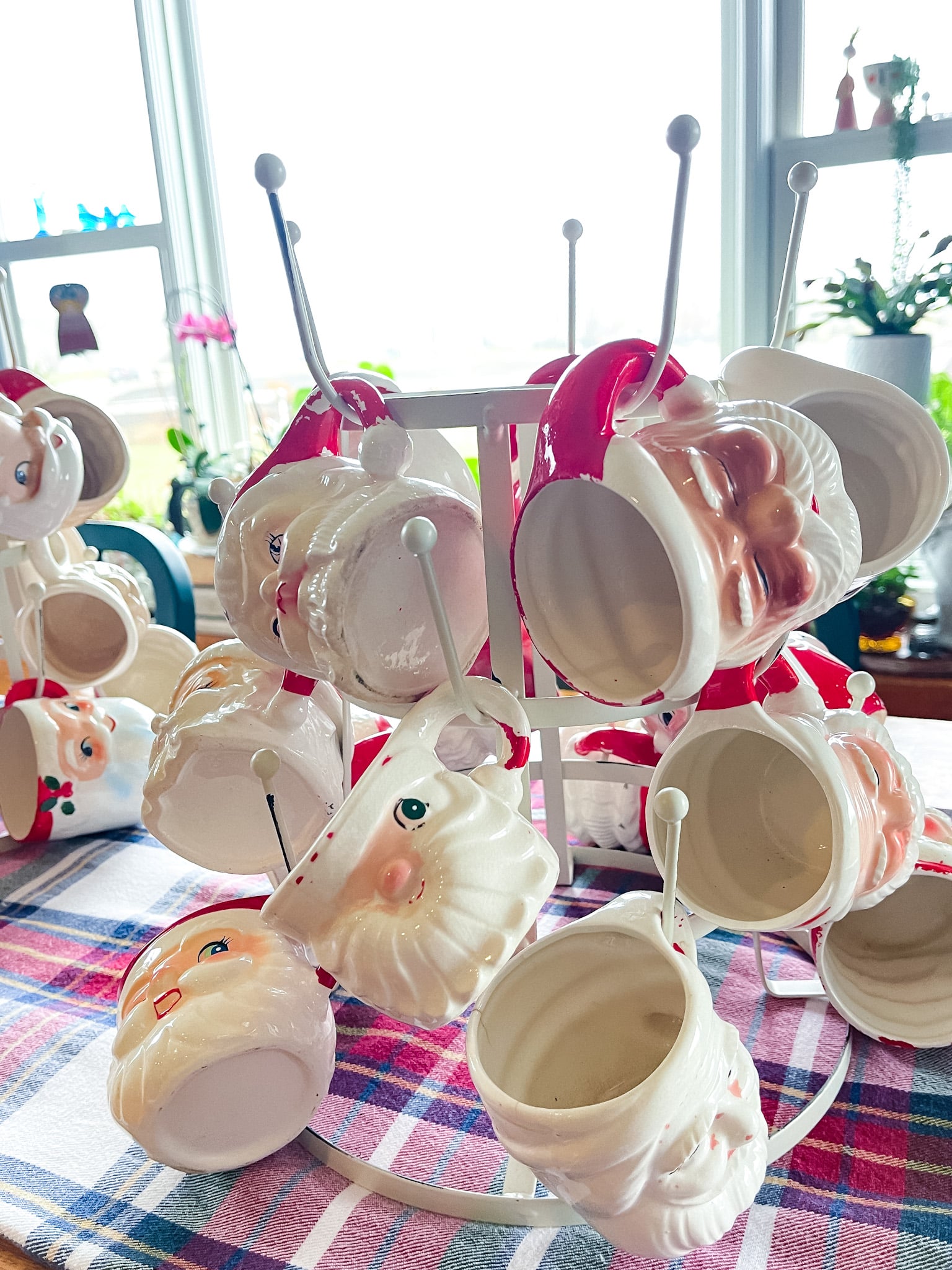 vintage santa mugs on a mug rack