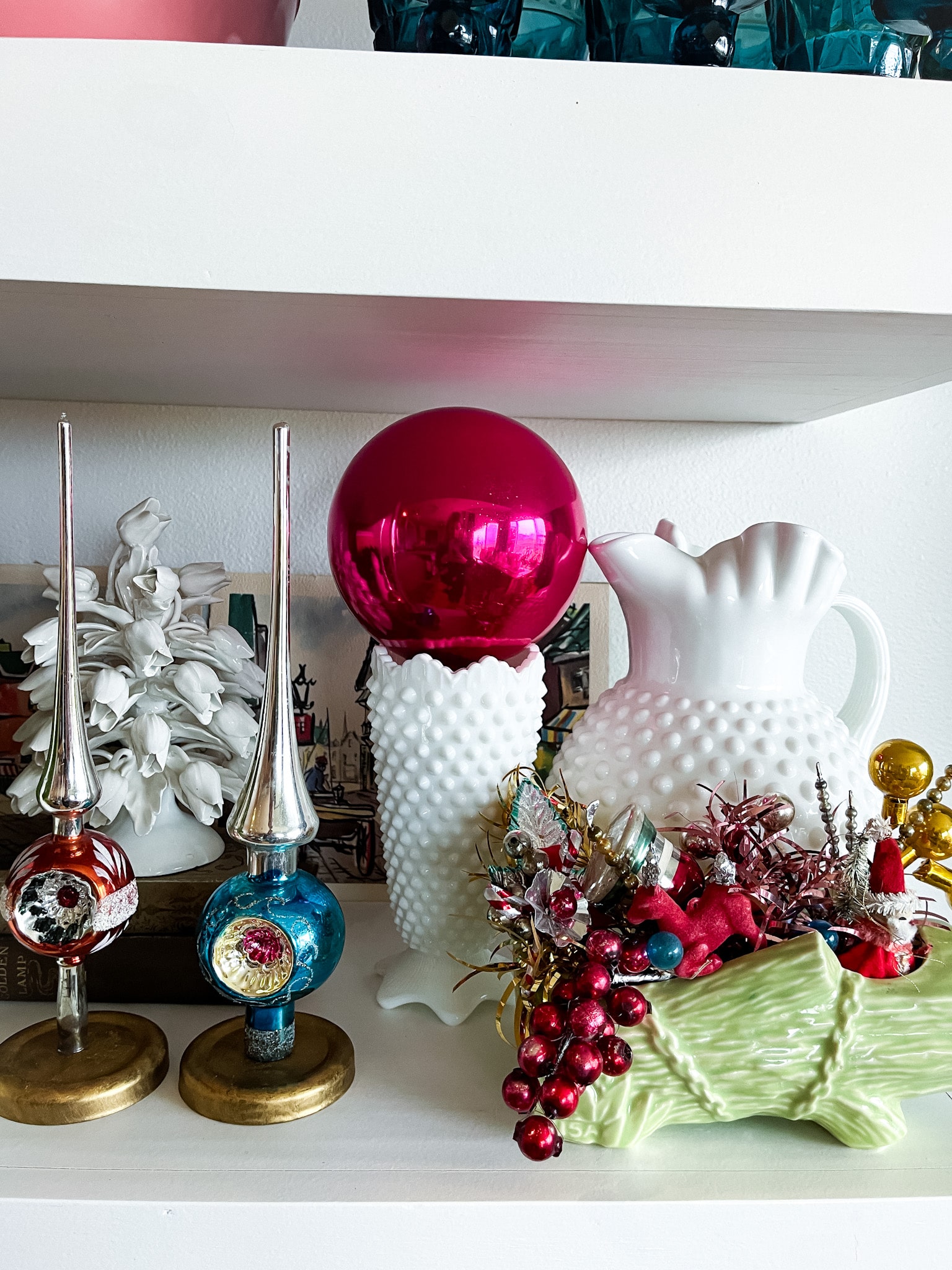 floating shelves with milk glass and vintage shiny brites and shiny brite tree toppers