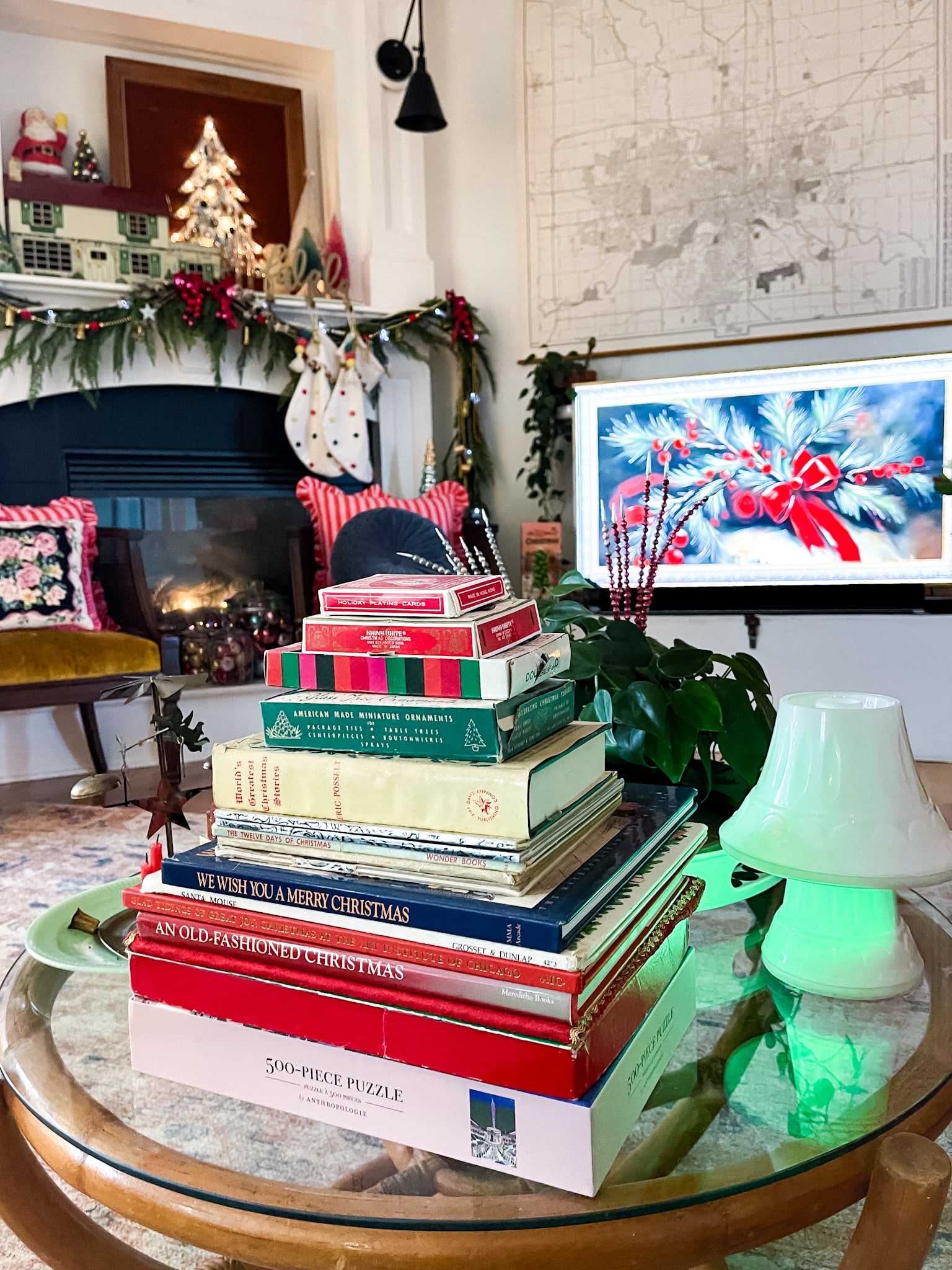 bamboo coffee table filled with vintage christmas decorations with a fireplace in the background and an art tv on