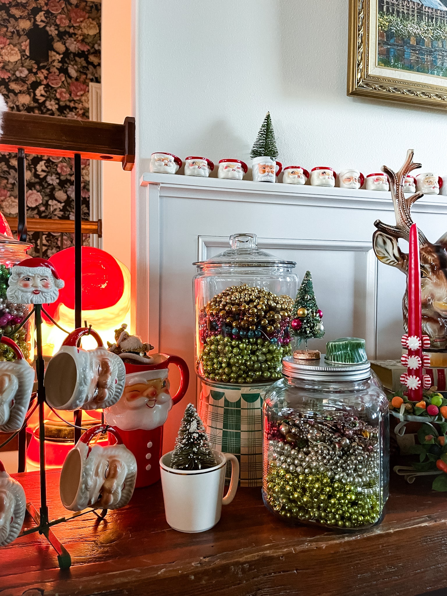 entryway decorated with vintage christmas decor, including putz houses, mercury glass garland, and other vintage decor
