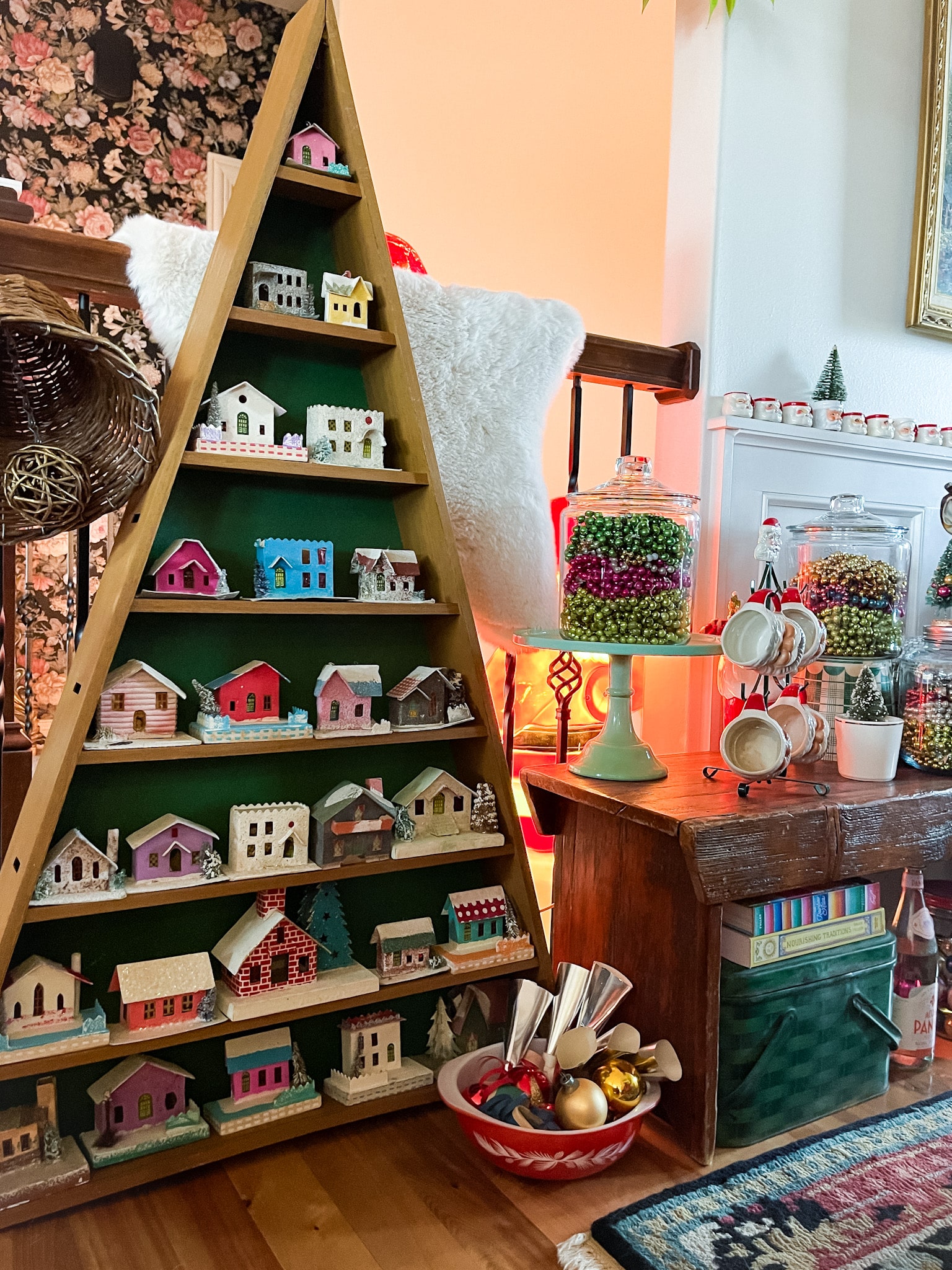 entryway decorated with vintage christmas decor, including putz houses, mercury glass garland, and other vintage decor