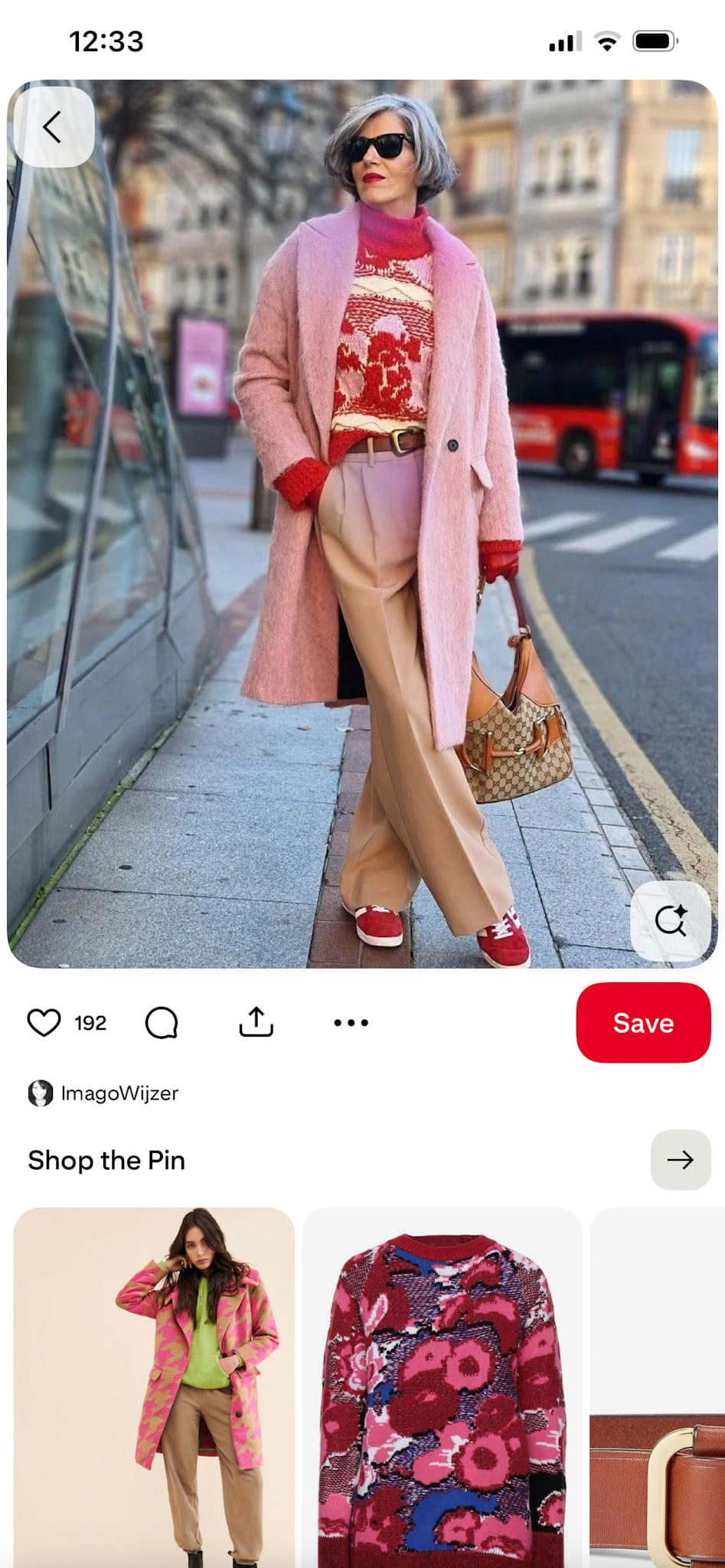 outfit inspiration photo: pink coat, graphic sweater, camel trousers, and red shoes